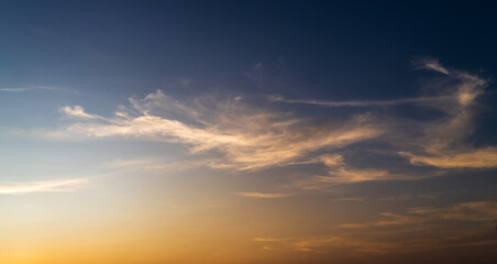 Wall Mural - sunset sky in the evening with orange sunlight clouds on dark blue, dusk sky background 