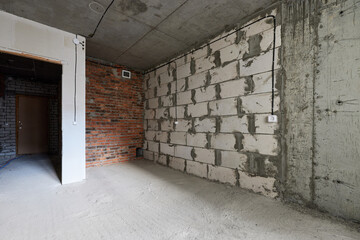  new apartment in rough finish. Brick wall. Housing stock concept. Real estate object