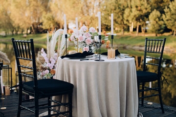 Wall Mural - Romantic dinner for two by the lake at sunset