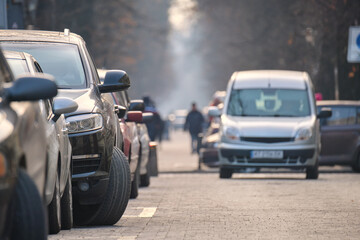 Wall Mural - City traffic with cars parked in line on street side