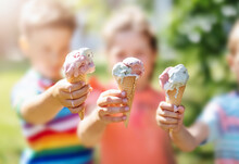Group Of Children In The Park Eating Cold Ice Cream.