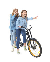 Sticker - Portrait of happy young sisters with bicycle isolated on white