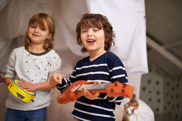 Poster - Family makes the best harmony. Portrait of two adorable siblings playing with their musical toys.