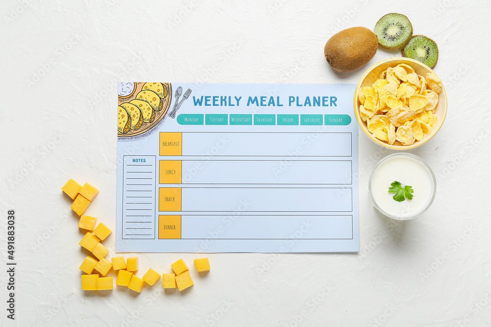 Weekly meal planner and different healthy products on light background