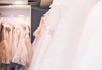 Wall Mural - Wedding dresses hanging on a hanger in a bridal salon