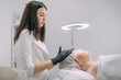 © Anna - Cosmetologist and dermatologist makes a moisturizing, rejuvenating woman lying patient in a beauty salon.