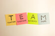 Colorful sticky notes with TEAM acronym (together everyone achieves more)