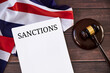 © photoguns - UK sanctions list against Russia, judge's gavel, flag of United Kingdom on wooden table.