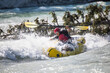 © Cavan Images - Man paddling white water raft flips after hitting huge rapid.