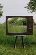 © Cavan Images - Girl in old television frame box outdoors