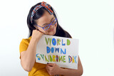 Fototapeta Panele - Trisomy 21,special needs,Young woman holds banner celebrating World Down Syndrome Day social inclusion cooperation