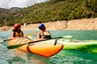 © Cavan Images - Front view of couple sailing on a mountain lake.