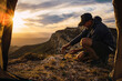 © Cavan Images - Man with cap cooking during a camping trip in the mountain.