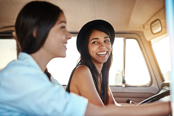 Wall Mural - Road trips are always a good idea. Shot of two happy young friends going on a road trip.