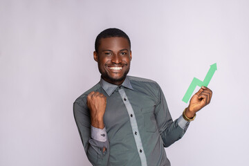 Wall Mural - excited african man holding an upward graph symbol