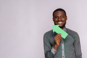 Wall Mural - excited black man holding and arrow pointing sideways