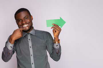 Wall Mural - excited african man holding and arrow pointing sideways