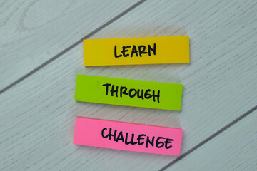 Wall Mural - Learn - Through - Challenge write on sticky notes isolated on Wooden Table.