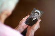 © C S W/peopleimages.com - One day we will meet again. Cropped shot an elderly woman holding an old black and white photograph of a man.