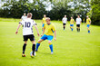 © Mariusz S/peopleimages.com - Playing good defense. A group of soccer players in the middle of a game.