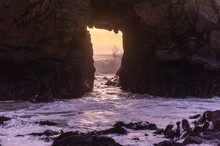 A Sunset Sky Peeping Thought The Keyhole Arch At Pfeiffer Beach, Near Big Sur California.