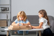 © Volodymyr - Kids open pizza box at home. Pizza kids delivery. Surprised children is astonished by a big box with a huge pizza, very surprised and happy.