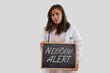 © fabio - Serious female doctor holding blackboard with Neocov alert. New kind of coronavirus. Isolated on grey background.