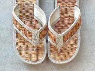 Flip flops are made from natural materials such as straw. Hand made shoes.pair of slippers.