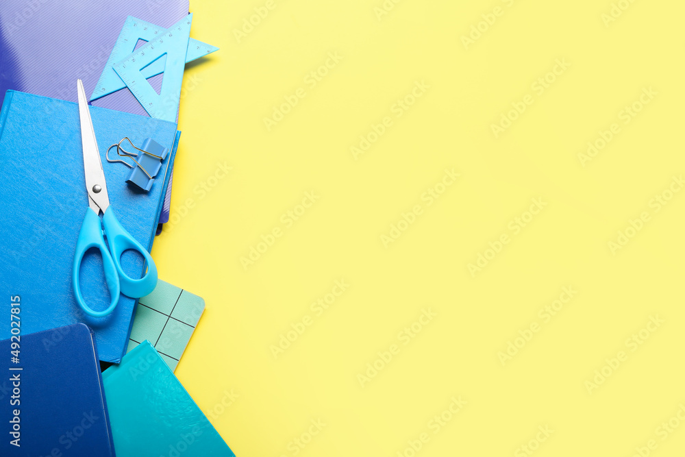 Set of colorful stationery on yellow background