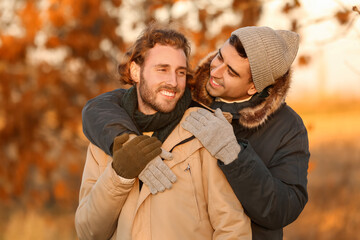 Wall Mural - Portrait of happy gay couple in autumn park