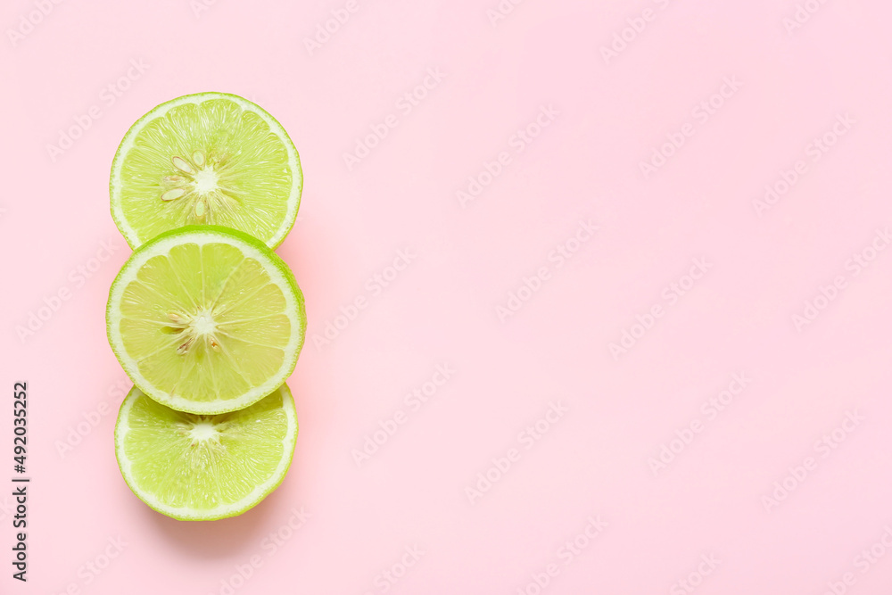 Slices of ripe bergamot fruit on pink background