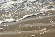 Tiny Waves On Sandy Beach