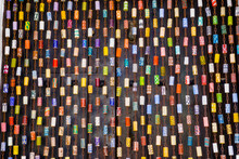 Colorful Original Fly Curtain Made Of Chain And Painted Wine Corks In Front Of A Dark Brown Door