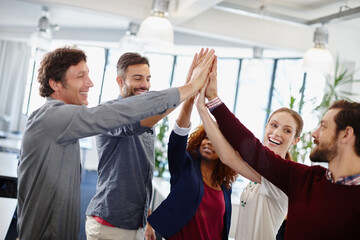 Wall Mural - Another project, another satisfied client. Shot of a team of businesspeople giving each other a high five in the office.