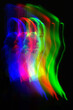 © Rytis - Abstract woman silhouette portrait in bright light trails of light painting in RGB split style of red, green and blue colors. Long exposure photo. Image contains noise and motion blur