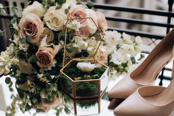 Poster - Wedding accessories. Bride's bouquet of pastel roses and gold rings