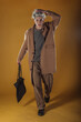© qunica.com - Portrait of a smart young man standing against yellow backgroun