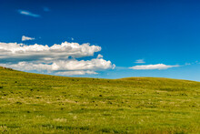 Bright Sunny Rural Fields With A Few Clouds In The Sky In The Prairies During Spring.