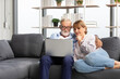 © offsuperphoto - senior couple using laptop computer on sofa
