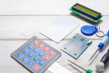 Wall Mural - door access control keypad, magnetic key, card and display on the white background.