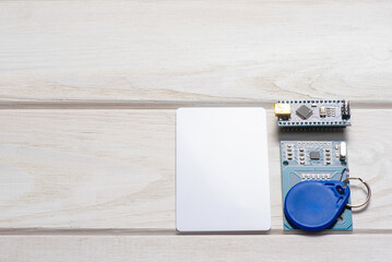 Wall Mural - magnetic key, card and module on the white flat lay background with copy space.