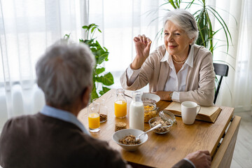 Wall Mural - Elderly couple in love. Senior husband and wife hugging and bonding with true emotions