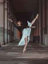 Slim Woman Performing Arabesque Ballet Pose Standing In Pointe Shoes