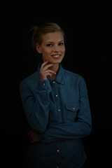 Canvas Print - Positive thoughts brighten up a dark world. A young woman standing with her hand on her chin wearing a denim shirt.