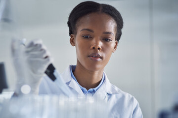 Wall Mural - ensuring the cure is up to standard. shot of a young scientist working in a lab.