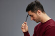 © SHOTPRIME STUDIO - man in a sweater with pen posing emotions business and office concept
