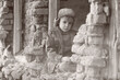 © Jacek - Child and war. Little, poor boy in the ruins of a bombed house.