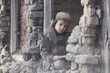 © Jacek - Child and war. Little, poor boy in the ruins of a bombed house.