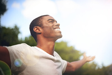 when life smiles at you, smile back. shot of a man standing outside with his arms outstretched in de