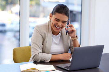 Wall Mural - Rumours are tumours, of the sick and mainly useless. Shot of an attractive young woman using her cellphone and laptop in a modern office.